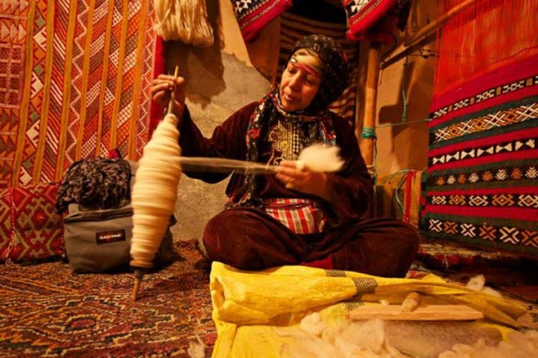 woman spooling wool morocco
